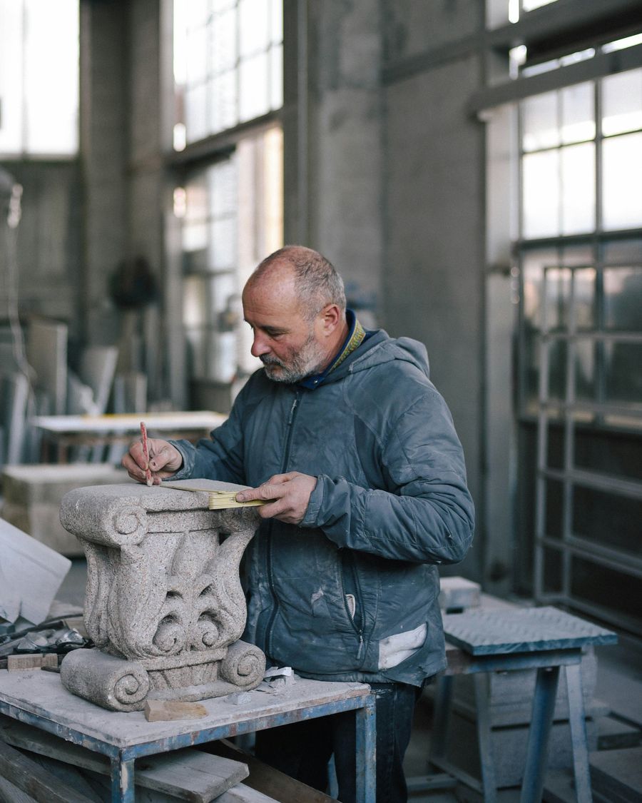 man carving stone