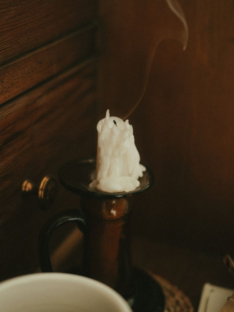 Smoke rising from a white candle that has just been blown out